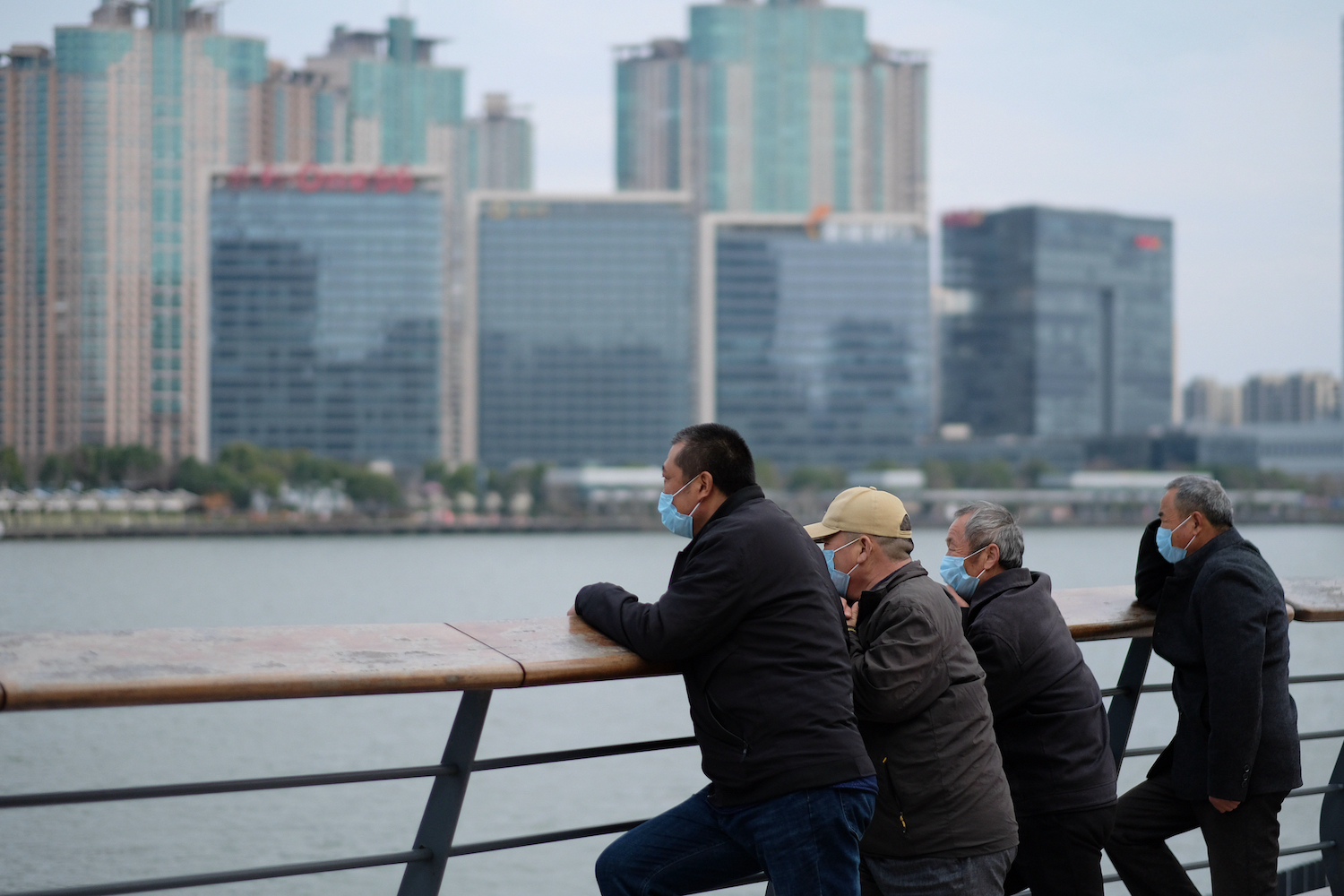 Older Chinese men look out at the city from afar